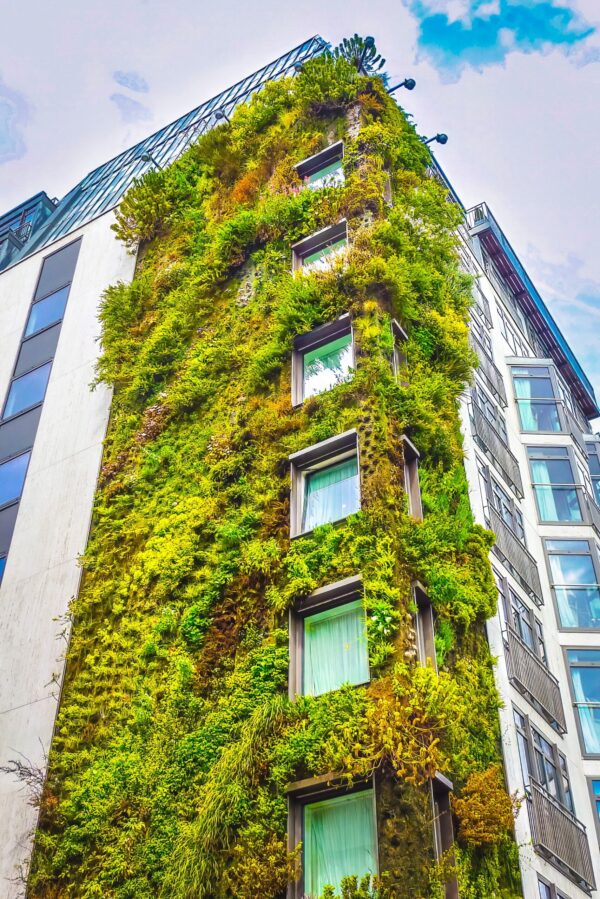 Modern UK high-rise building with greenery growing on it