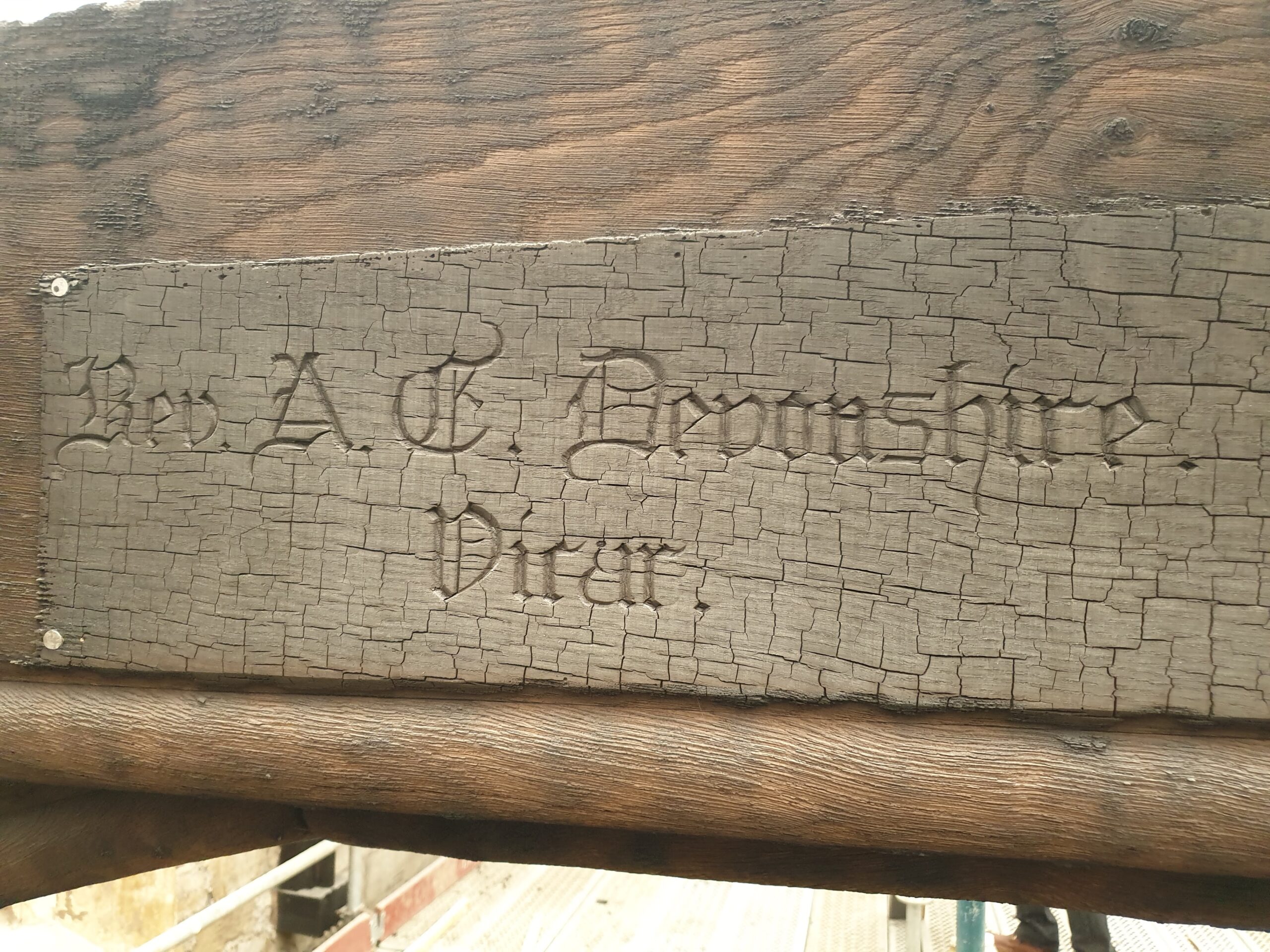 An old wooden plaque with the inscription 