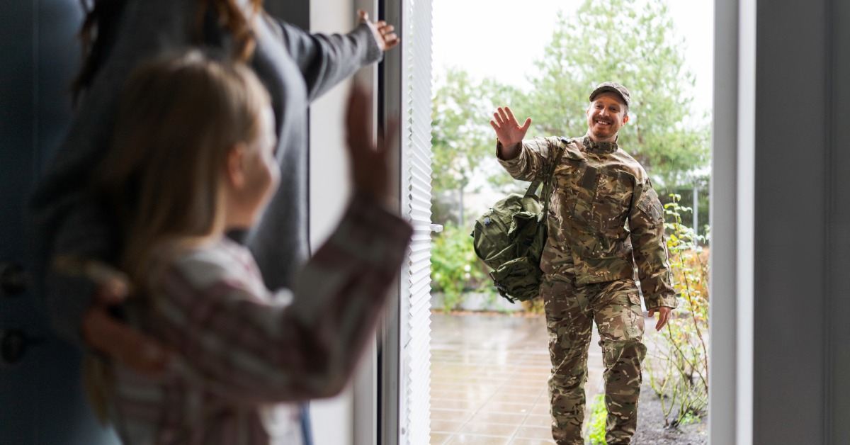 Military man greeting his family at his front door